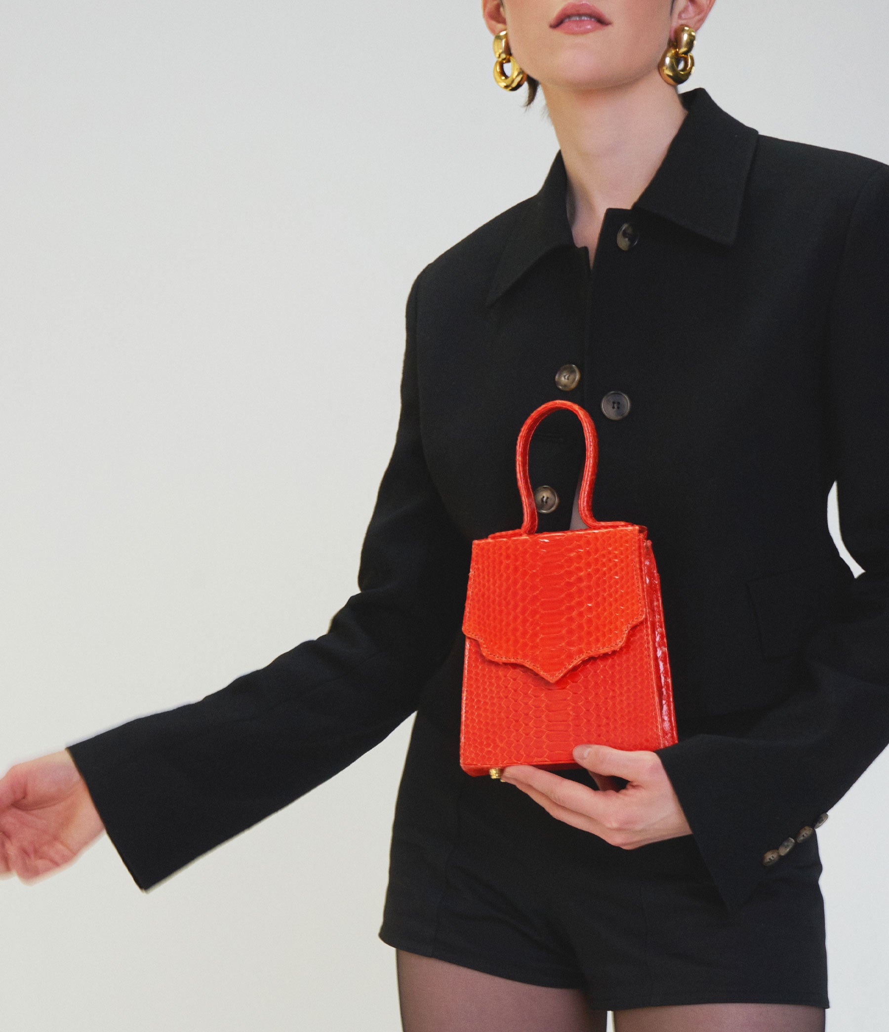 The Mini Missy in Hot Orange Python with Gold Hardware